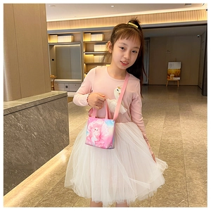 Girl wearing a pink canvas handbag with little mermaid princess print for kids