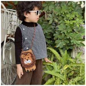 Handmade crochet lion crossbody bag for girls showing strap length and knit texture