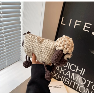 Detail of a handmade crochet sheep crossbody bag featuring cream and brown yarn textures