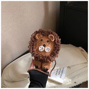 Detail of handmade crochet lion bag showing textured mane and soft knitted craftsmanship
