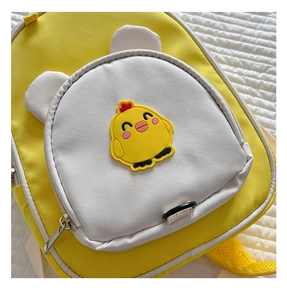 Close-up of cute yellow chick cartoon front pocket on a waterproof toddler backpack
