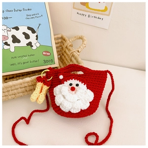 Detail of a handmade red crochet Santa Claus crossbody bag with warm holiday decor