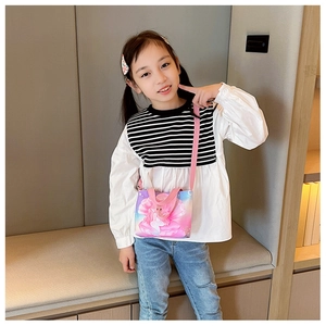 Pink cartoon mermaid canvas crossbody bag shown on a young girl in a stylish indoor setting
