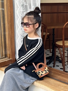 Detail view of mini leopard print crossbody bag with fashion glasses and casual outfit