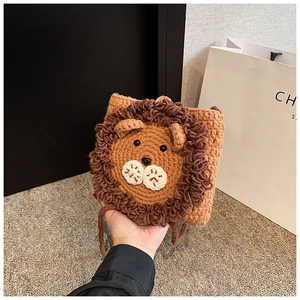 Detail of a handmade crochet lion bag for girls with soft yarn and 3D lion facial features
