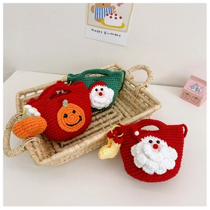Detail of handmade crochet Christmas bags featuring Santa Claus and pumpkin motifs