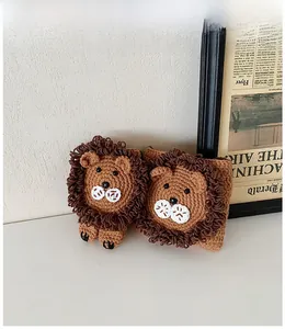 Detailed view of handmade knitted lion head accessories for children in brown yarn