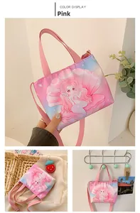 Detail of pink canvas tote with mermaid print, handles, and adjustable shoulder strap