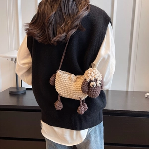 Handmade crochet sheep crossbody bag with white wool and 3D ears shown on a model