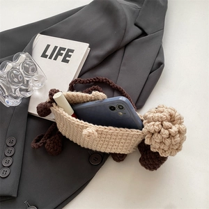 Handmade sheep crochet crossbody bag showing interior space for phone and lipstick