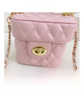 Close-up of pink quilted mini bucket bag with gold twist lock and chain strap