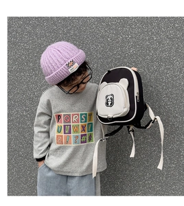 Detailed close-up of a cute panda backpack for kids with 3D ears and durable Oxford fabric