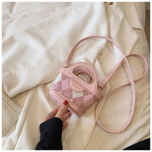 Detail of pink argyle knit mini handbag featuring MARAN logo and vegan leather strap