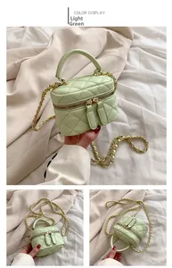 Detail view of mini light green quilted crossbody bag with golden chain and handle