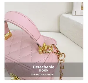 Detail of pink quilted leather bag with golden detachable hook and metal chain strap