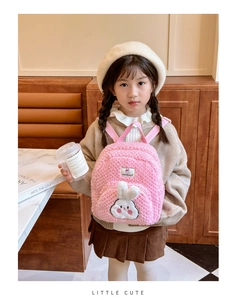Detail of cute pink fleece toddler backpack with a white 3D bunny character and brand tag