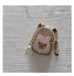 Detail of cute cartoon bear backpack with breathable mesh shoulder straps and 3D ears