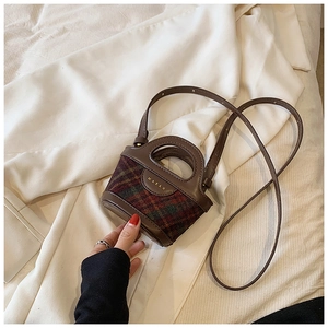 Close-up of mini plaid tweed handbag with leather trim and MARAH brand logo detail