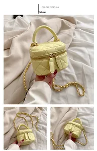 Macro detail of yellow quilted vanity bag with gold chain strap and zipper closure