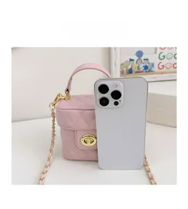 Detailed comparison of mini pink quilted bucket bag next to a smartphone for scale