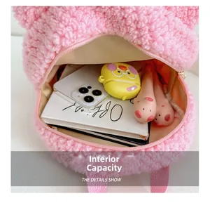 Macro view of plush pink rabbit backpack interior showing storage capacity and soft lining