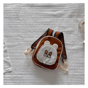 Detail of cute corgi cartoon embroidery on waterproof oxford kids backpack with small ears