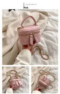 Detailed view of pink quilted mini vanity bag with gold chain strap and dual zippers