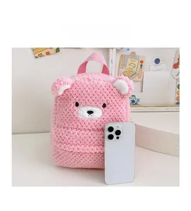 Detailed comparison of pink plush bear toddler backpack size with a smartphone
