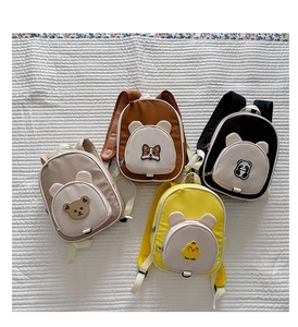 Detail view of colorful cartoon animal patches on water-resistant oxford fabric backpacks