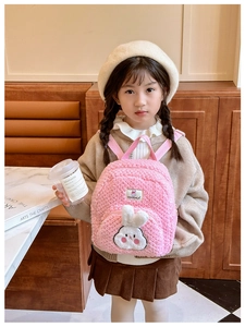 Close-up of pink plush bunny backpack featuring soft fleece fabric and cute 3D rabbit ears