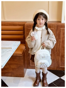 Close-up of white plush bunny backpack for toddlers featuring soft lamb wool material
