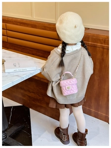 Pink quilted bucket bag for girls featuring a gold chain strap and twist lock detail