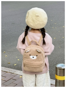 Detail of cute plush bear toddler backpack with 3D ears and soft sherpa texture