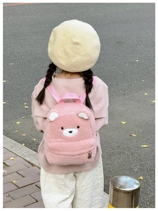 Pink plush bear backpack for toddlers with soft sherpa texture and metal bunny pendant