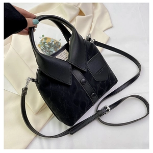 Detail of creative black bucket bag featuring a shirt collar lid design and side pocket