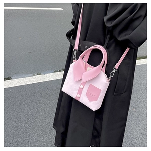 Detail of pink creative shirt-style crossbody bag showing collar and button accents