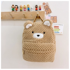 Detail of cute brown plush bear backpack showing soft sherpa texture and embroidered ears