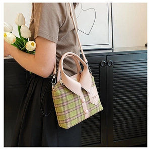 Detail of plaid fabric handbag featuring a creative shirt collar design and top handle