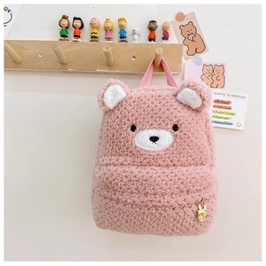 Detail of pink sherpa fleece toddler backpack with cute bear ears and golden rabbit charm