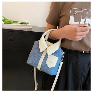 Blue denim crossbody bag featuring creative white collar detail and shoulder strap