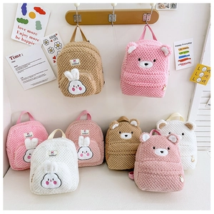 Detail showing plush rabbit and bear backpacks with soft fleece texture and zipper closures