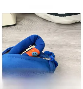 Close-up of royal blue fabric bag featuring a metal zipper and orange smiley face patch