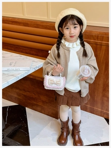 Kids sequin handbag with pearl handle and bow accent worn with autumn outfit