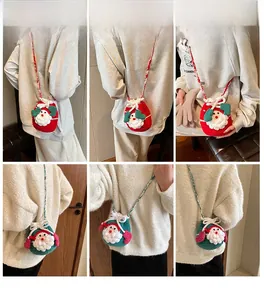 Close-up of handmade crochet Christmas Santa bags in red and green woven yarn