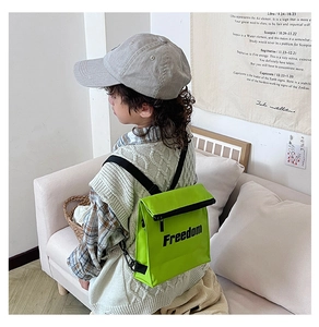 Rear view of a child wearing a vibrant neon green Freedom letter print backpack
