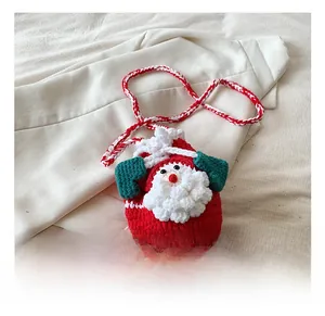 Detail of handmade crochet Santa Claus drawstring bag with red and white woven strap