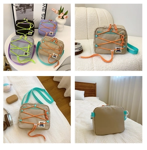 Detail of trendy nylon kids crossbody bags in black, purple, grey and khaki with bear patch