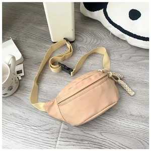 Detail of beige canvas kids fanny pack with woven zipper pull and adjustable strap
