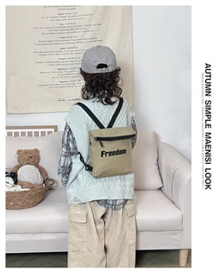 Detail of khaki canvas kid's backpack with Freedom letter print and adjustable straps