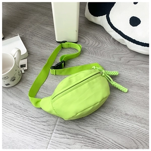 Detailed macro view of fluorescent green nylon waist bag with woven rope zipper pull